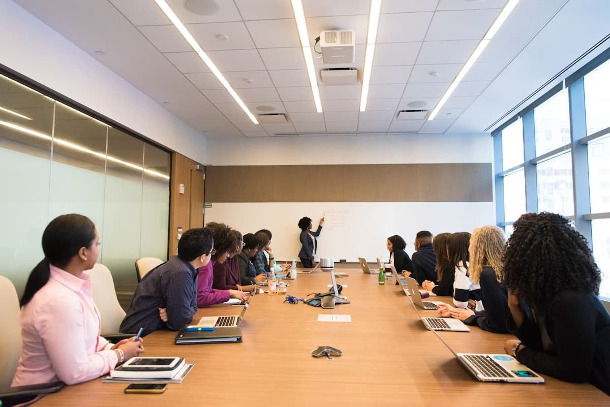 Cambly Promo Code 2026: Up to 60% Off English Lessons Group English conversation class with diverse students and a teacher presenting on Cambly