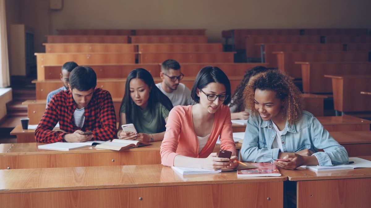 LingQ Promo Code 2026: Save Up to 35% on Premium Language Learning Students using smartphones and digital devices for language learning with LingQ app