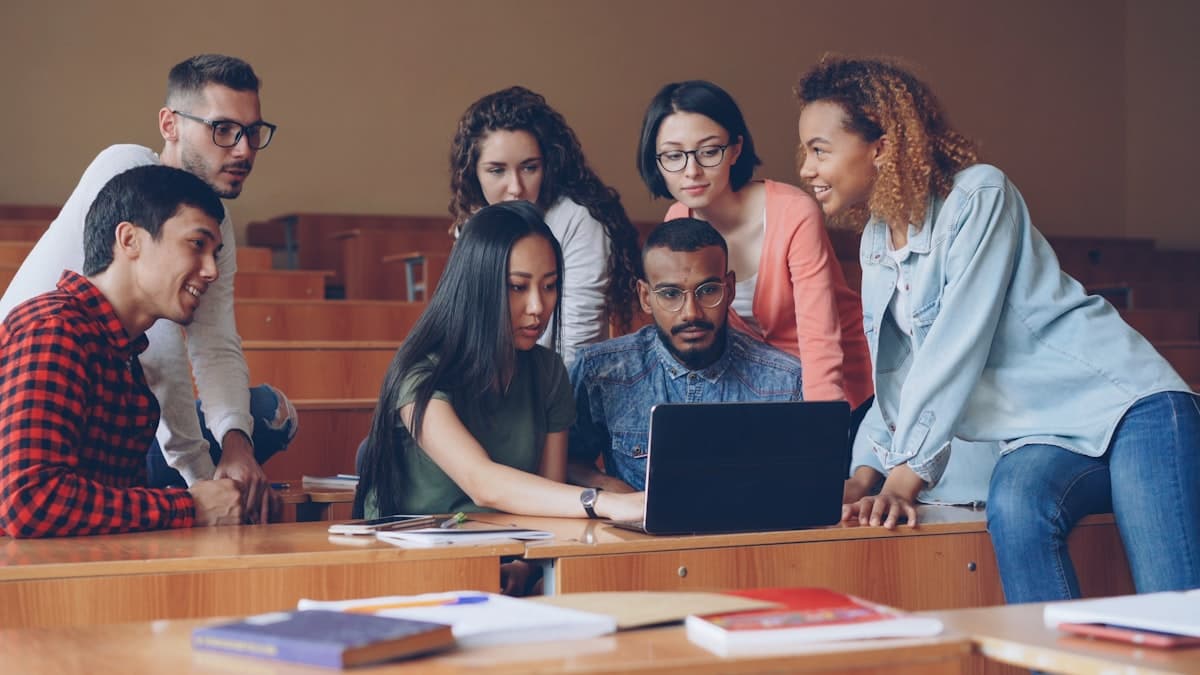 Preply Promo Code 2026: Every Discount Preply Actually Offers Diverse group of students gathered around a laptop studying together on Preply